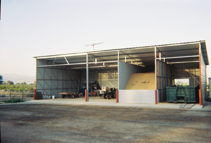 Three sided building with Shed roof and metal siding